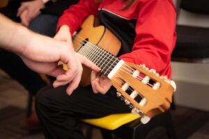 kids playing and learning guitar