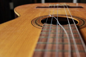 broken guitar strings on acoustic guitar