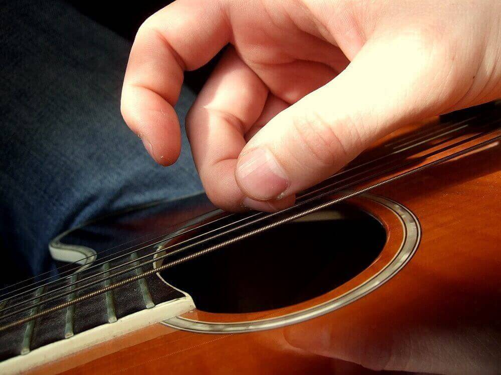 strumming a guitar