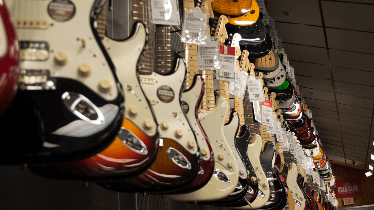 guitars hanging on display at a store