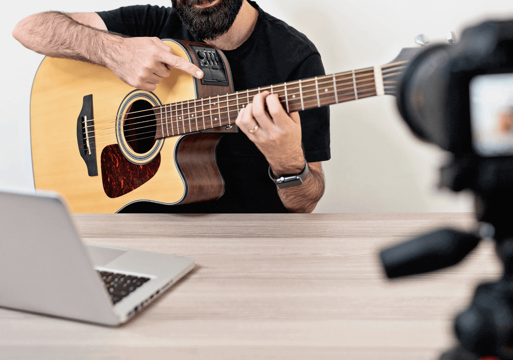 camera guitar player laptop