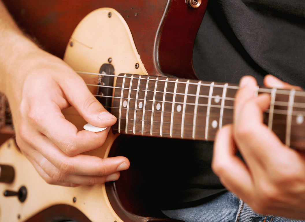 how to play artificial harmonics on a guitar